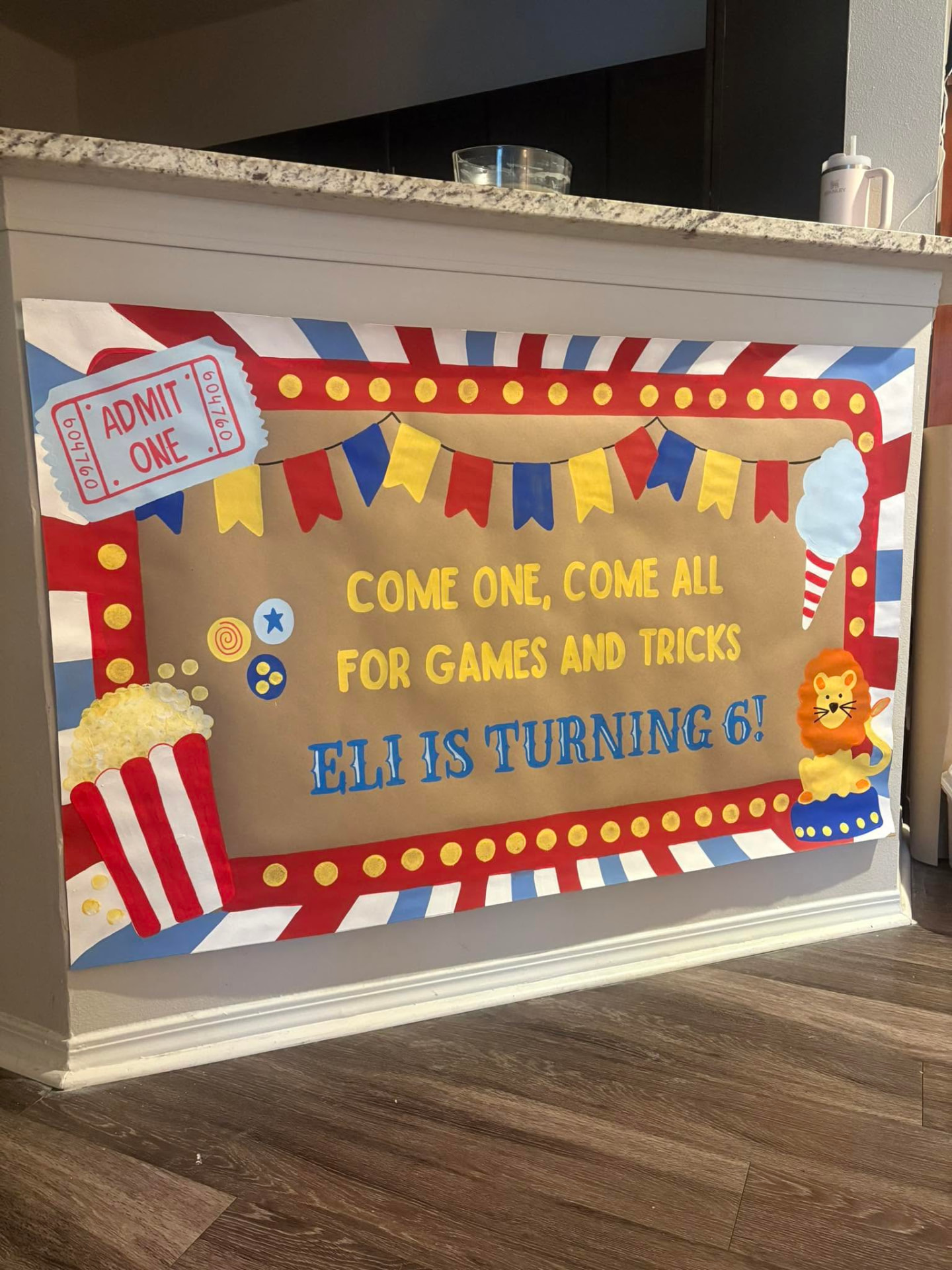 Colorful hand-painted carnival birthday banner with popcorn, bunting, and a lion